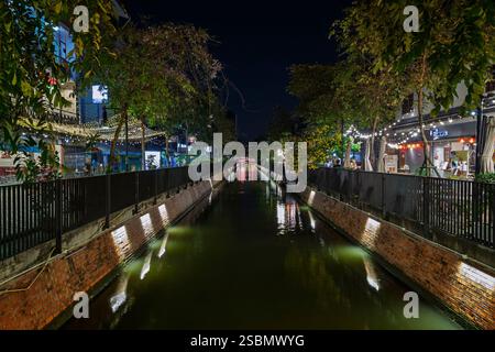 Restaurants and other small businesses by a small canal at the Chinatown in Bangkok, Thailand, in the evening. Stock Photo