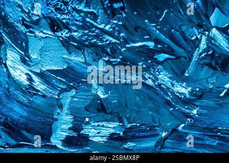 Abstract background with the texture of plaster or oil paint in rich blue color. Seamless background with large brush strokes. Rough stylized texture Stock Photo