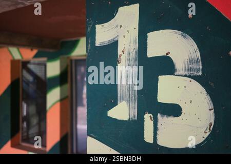 Painted walls at the entrance to the building with the number thirteen. Stock Photo