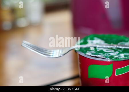 a set of silver forks resting on a red and white paper napkin. Stock Photo