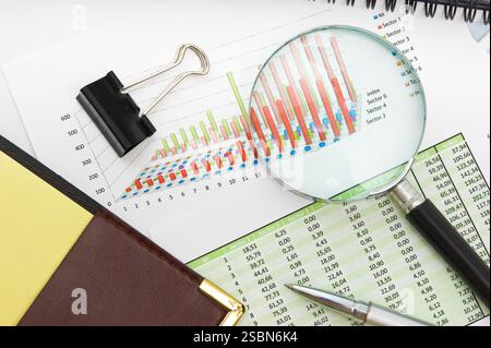 Graphs tables and documents laid on the table Stock Photo
