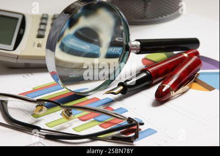 Graphs tables and documents laid on the table Stock Photo