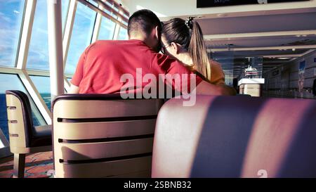 back view of woman and man in a relationship sitting in the lounge bar of the ferry on the route from Bari to Dubrovnik Stock Photo