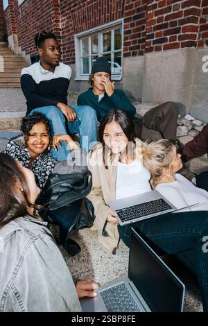 Group Of Young male And Female College Students Classmates Turning At ...