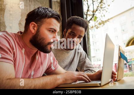 Low angle view of businessmen using laptop in tech startup office Stock Photo