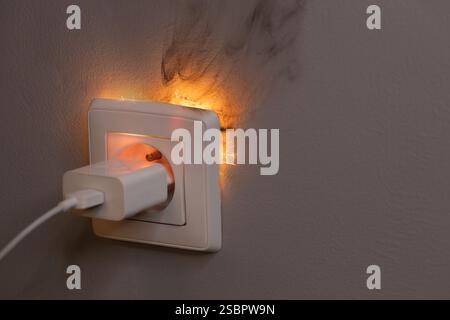 Electrical Short Circuit in Wall Socket with Sparks Stock Photo
