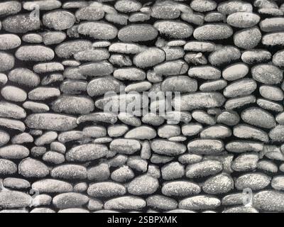 Close up of black and grey coarse stone or black pumice stacked on each other printed on wallpaper. Seamless stone pebbles wall covering background Stock Photo