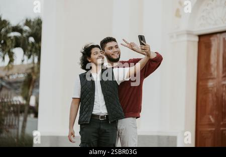 Cheeful friends taking funny selfie on the street. Portrait of funny friends taking a selfie on the street Stock Photo