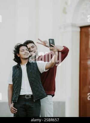 Cheeful friends taking funny selfie on the street. Portrait of funny friends taking a selfie on the street Stock Photo