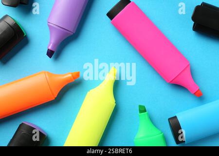 Bright highlighters on light blue background, flat lay Stock Photo