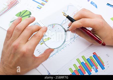 Graphs tables and documents laid on the table Stock Photo