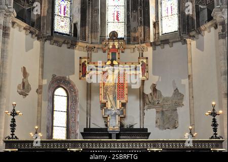 Basilica of St Francis of Assisi, Unesco World Heritage Site Assisi, Italy, Richly detailed chancel with a cross and decorated stained glass windows, Stock Photo