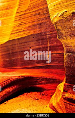 A rock formation with a red stripe. The rock is orange and brown Stock Photo