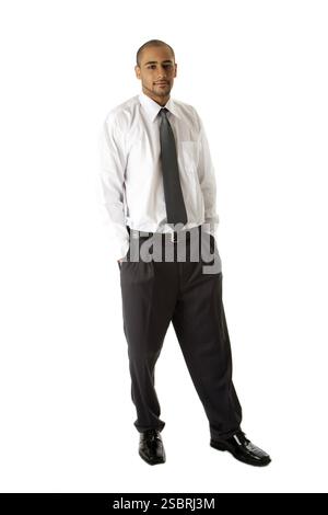 Handsome African Hispanic business man in white shirt, grey pants and tie, standing with hands in pocket, isolated, New York, USA, North America Stock Photo
