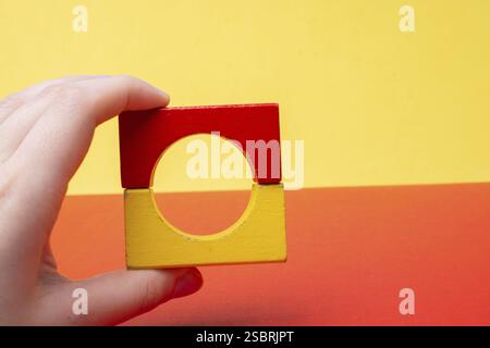 Hand building tower with colorful building blocks Stock Photo