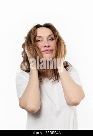 Happy mature woman laughing standing isolated on white background. Smiling confident cheerful middle aged 50s lady with dental white smile looking at Stock Photo