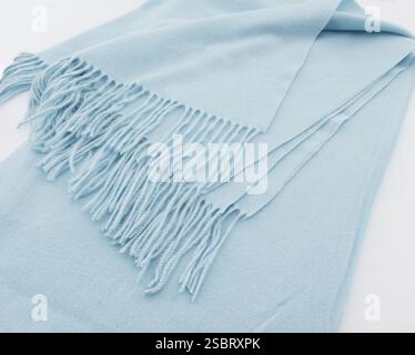 Close-up of fringe of soft warm light blue scarf or plaid Stock Photo