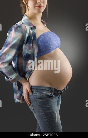 pregnant woman caressing her belly over white Stock Photo - Alamy