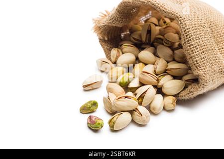 Sack with pistachio nuts, isolated on white background. Stock Photo