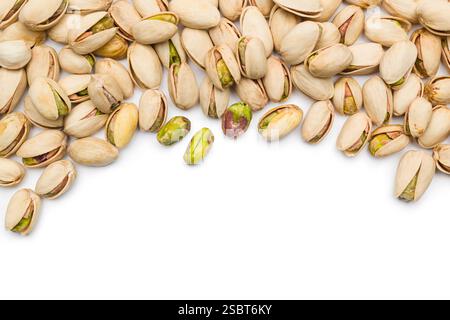 Top view of pistachio nuts scattered on white background with copy space. Stock Photo