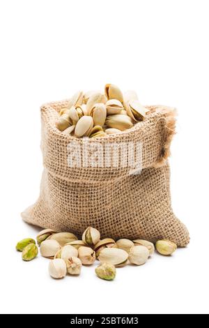 Sack with pistachio nuts, isolated on white background. Stock Photo