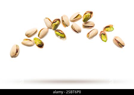 Pistachio nuts flying isolated on white background. Stock Photo