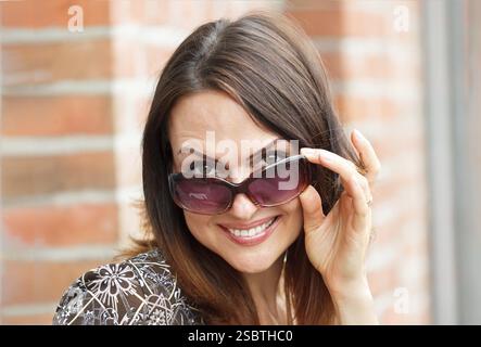 Portrait Of Young Smiling Beautiful Woman. Beautiful young fashion model posing outdoor. Summer outdoor portrait Stock Photo