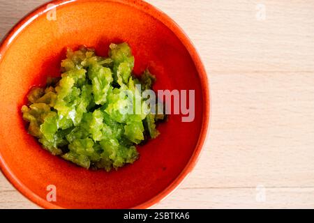 UK: A small bowl of home made green chilli paste. Food preparation for Indian cooking or cuisine at home. Used in curry Stock Photo