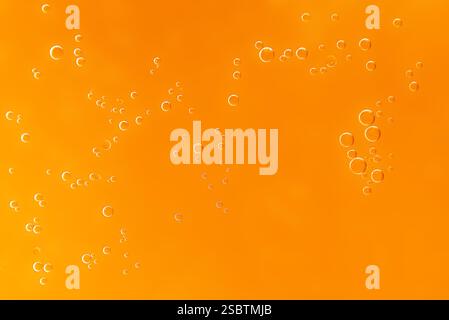 Golden yellow oil drops, abstract background Stock Photo