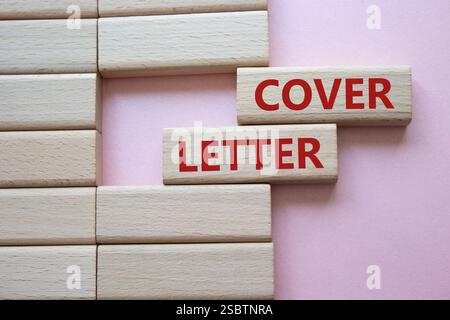 Cover Letter symbol. Concept word Cover Letter on wooden blocks. Beautiful pink background. Business and Cover Letter concept. Copy space Stock Photo