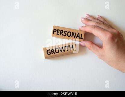 Personal growth symbol. Wooden blocks with words Personal growth. Beautiful white background. Businessman hand. Business and Personal growth concept. Stock Photo