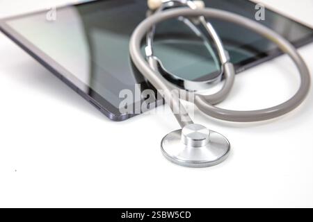 Telemedicine, medical stethoscope and digital tablet on white, closeup view Stock Photo