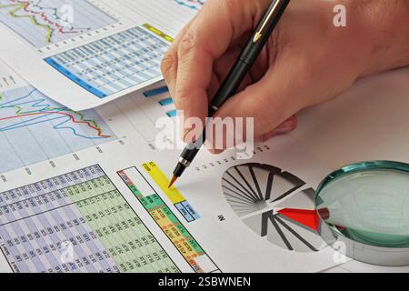 Graphs tables and documents laid on the table Stock Photo