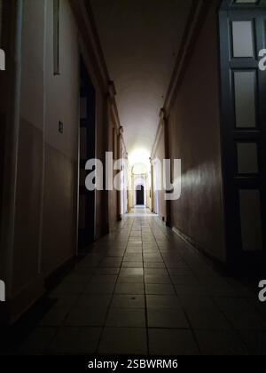 View through dark corridor with light at the end, in the main building of Odesa I. I. Mechnykov National University (Odesa National University, ONU) Stock Photo