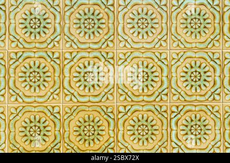 Traditional Portuguese ceramic tiles with an intricate green and gold pattern. Stock Photo