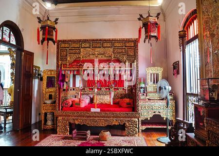 Ornately decorated Ceremonial wedding bed for the newly wed baba nyonya couples at Pinang Peranakan Mansion and Museum Stock Photo
