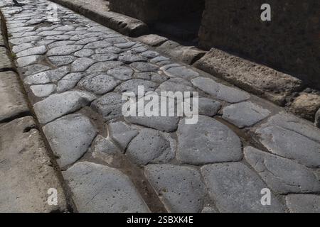Close-up of large grey smooth and worn lava stones in a street at the ancient ruins of Pompeii, Campania region, Italy, Europe Stock Photo