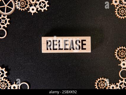 NEW RELEASE text on chalkboard on the wooden background. Stock Photo