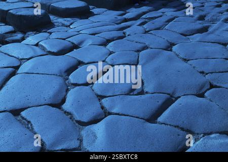 Close-up of large grey smooth and worn lava stones in a street at the ancient ruins of Pompeii, Campania region, Italy, Europe Stock Photo