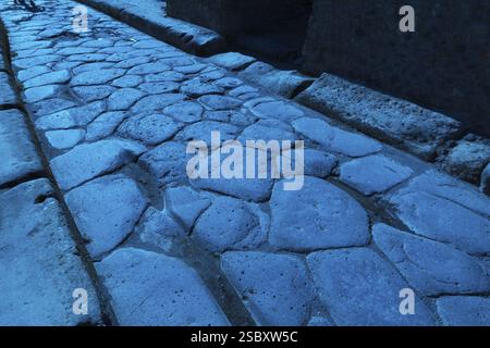 Close-up of large grey smooth and worn lava stones in a street at the ancient ruins of Pompeii, Campania region, Italy, Europe Stock Photo