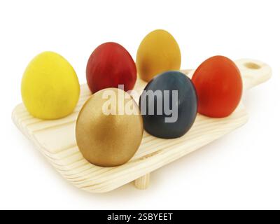 Multicolored Easter Eggs In Wooden Stand Against White Background Stock Photo