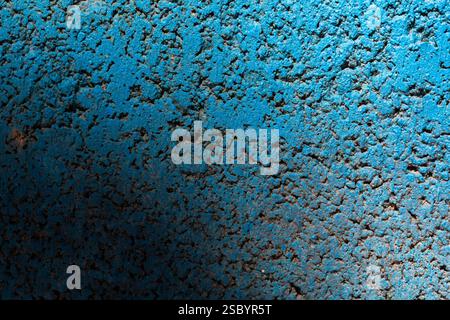 Texture of a concrete block painted blue, shaded in the evening light Stock Photo