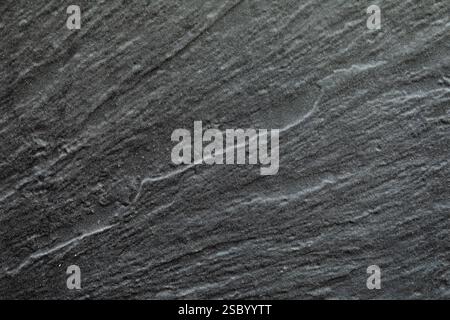 Abstract lines on an elegant dark gray slate texture, on the facade of a building Stock Photo