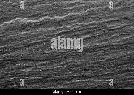 Dark gray background texture, of a slate type stone, used in the wall of a building, very common in civil construction Stock Photo