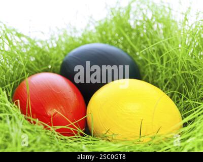 Three Multicolored Eastern Eggs In Fresh Green Grass Stock Photo