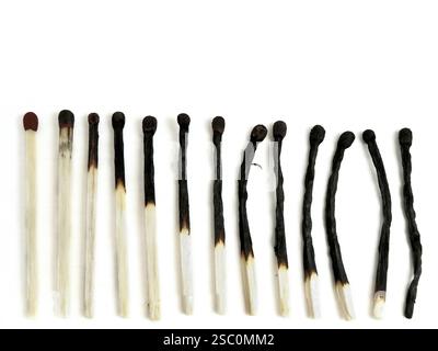 Row of burned-out matches over the white background Stock Photo