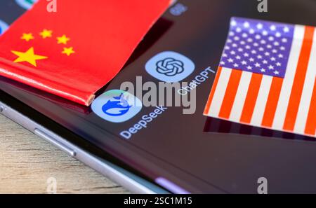 London. UK- 02.02.2025. An AI technology competition concept with the DeepSeek and ChatGPT app icon on a smartphone and the Chinese and American flag. Stock Photo