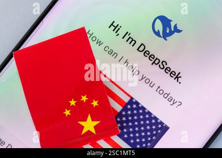 London. UK- 02.02.2025. An AI development competition concept with the home page of the DeepSeek chatbot app and the Chinese flag on top of the Americ Stock Photo