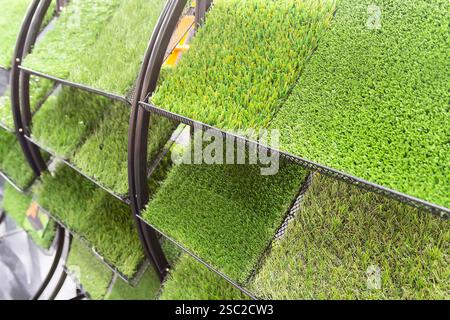 Samples of artificial lawn on the showcase. Industry Stock Photo