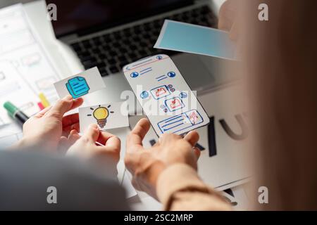 Creative team collaborating on UX UI design with wireframes and ideas. Stock Photo